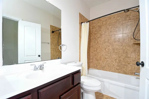 a bathroom with a sink a toilet and a large mirror