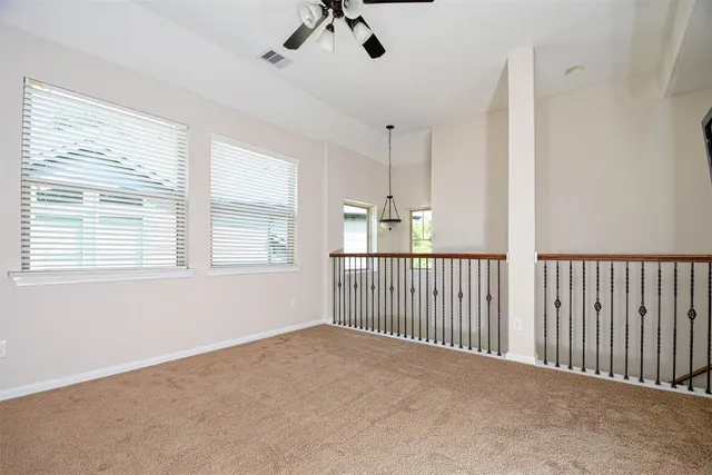 a view of a livingroom with a ceiling fan and window