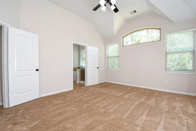 an empty room with windows and closet