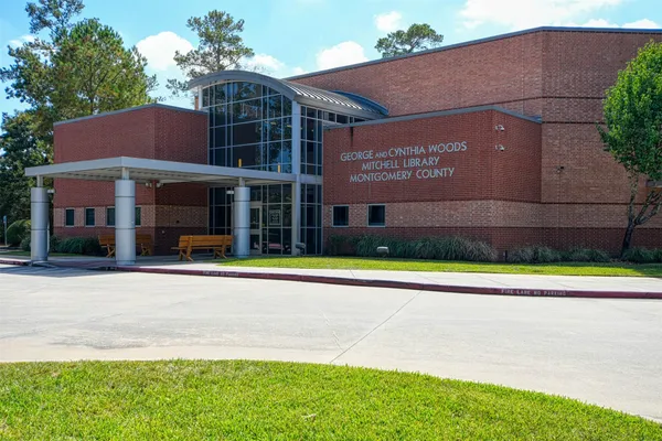 a view of a brick house with a swimming pool
