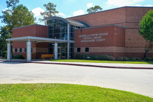 a view of a brick house with a swimming pool