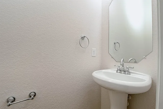 a bathroom with a sink and mirror