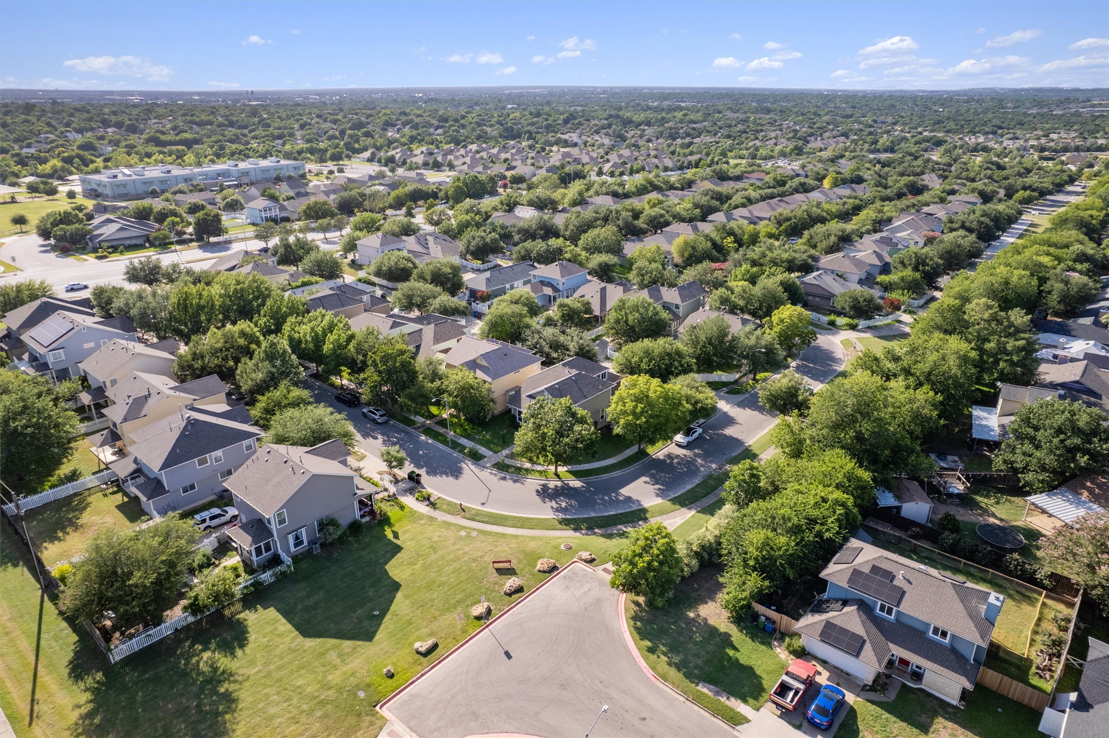 1833 Thompson Trail Round Rock, TX 78664 - Photo 37 of 40 An aerial perspective showcases a vibrant, tree-filled neighborhood with residential homes lining winding streets.
