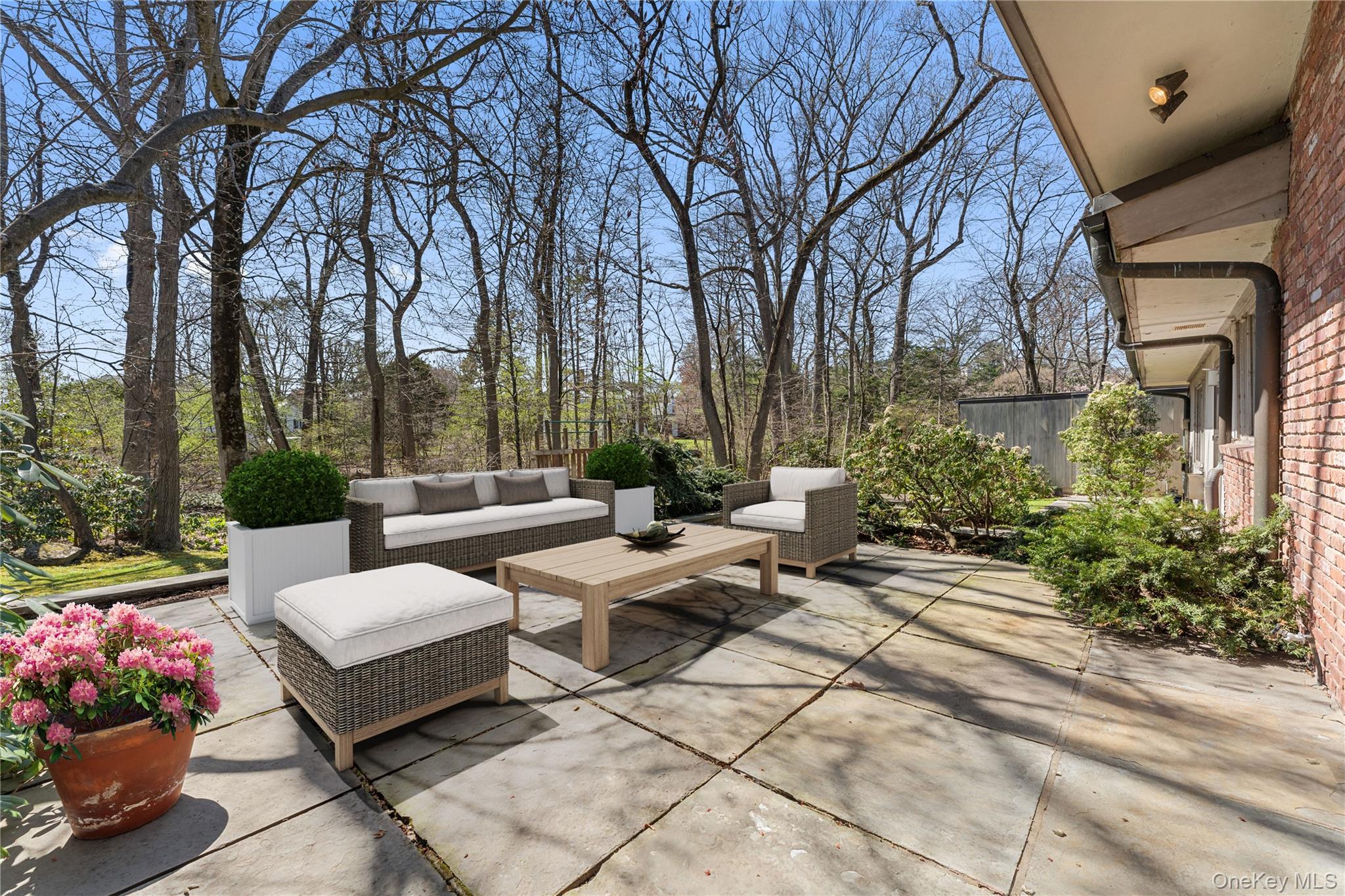 98 Cushman Road Scarsdale, NY 10583 - Photo 42 of 43 a view of a patio with couches and chairs under an umbrella
