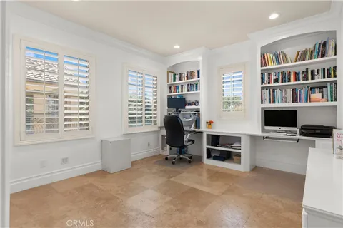 a view of a livingroom with workspace and a window