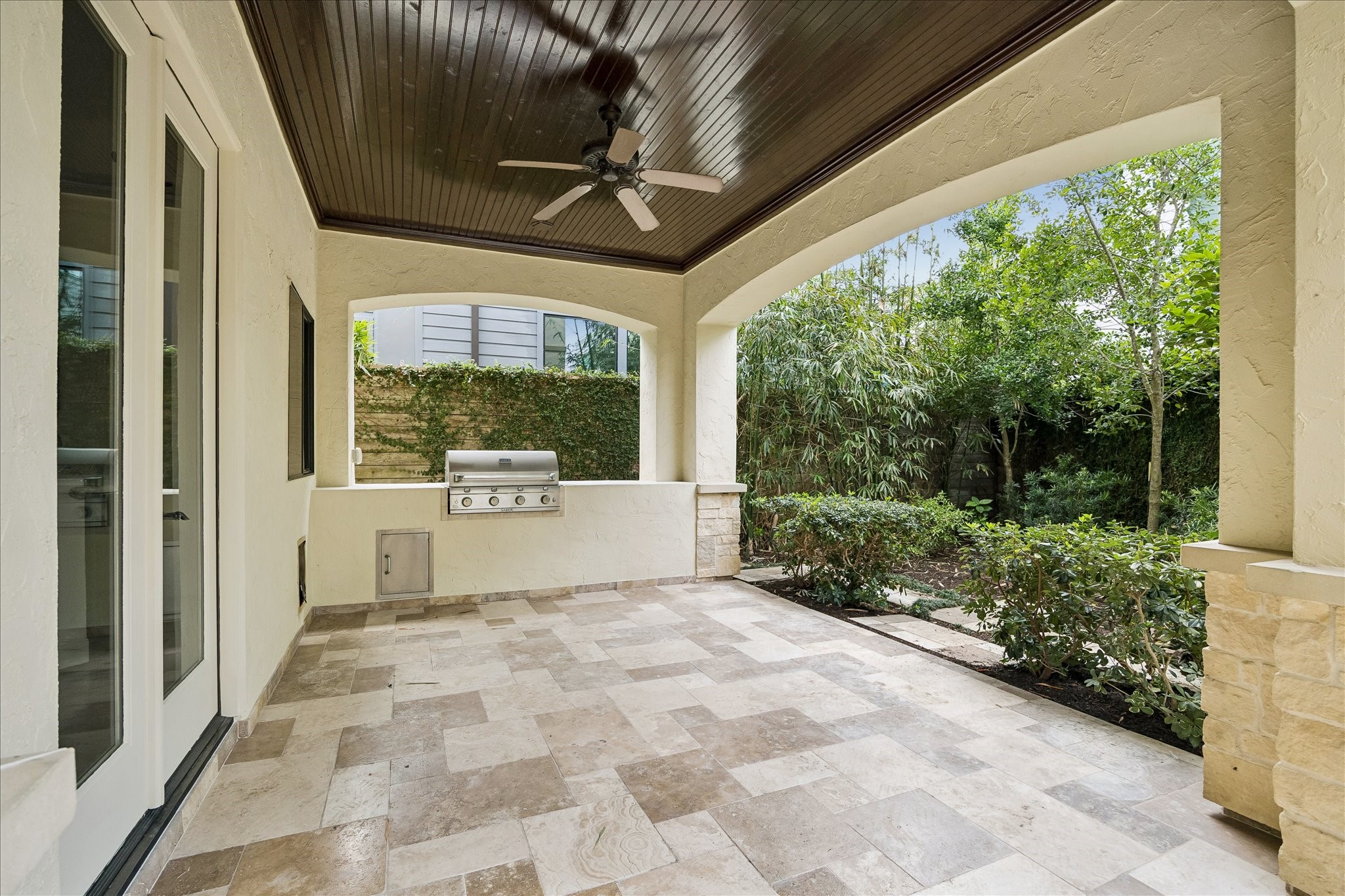 2246 Branard Street Houston, TX 77098 - Photo 38 of 40 Private landscaped grounds surround the spacious patio, offering a peaceful setting for outdoor dining and year-round enjoyment.