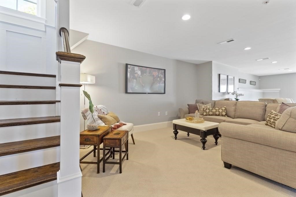 7 Waterville Lane, Unit 7 Hopkinton, MA 01748 - Photo 19 of 31 a living room with furniture and a lamp