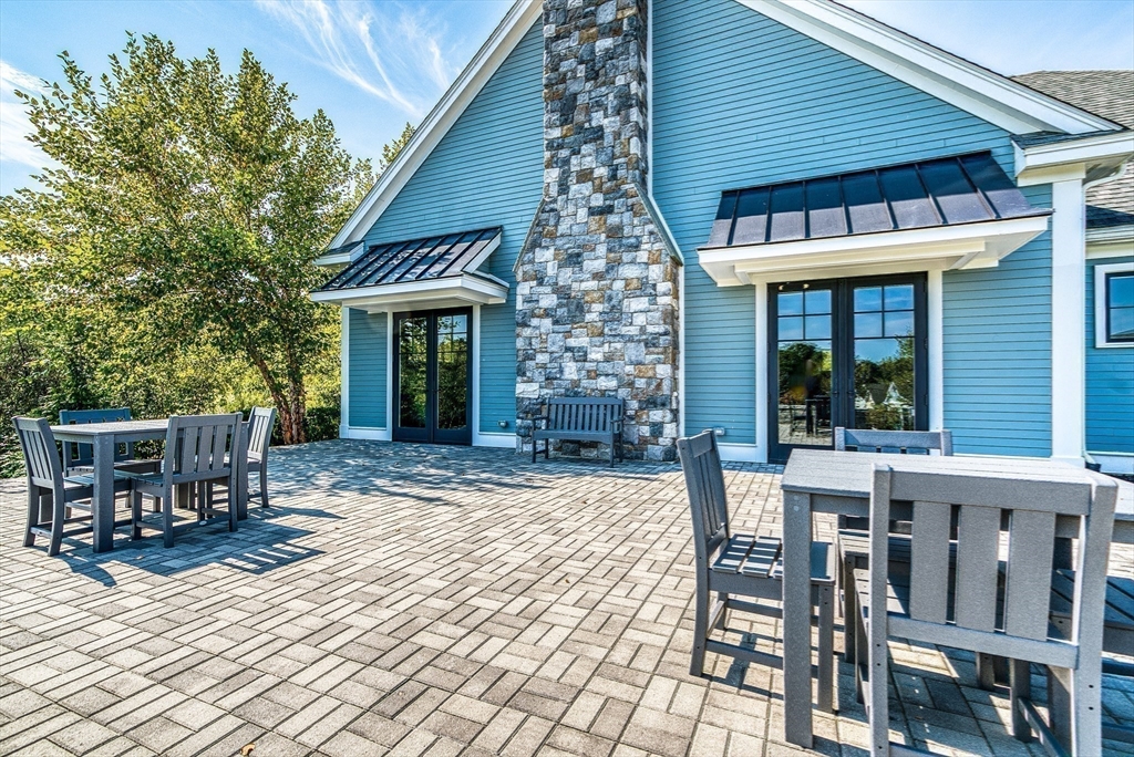 7 Waterville Lane, Unit 7 Hopkinton, MA 01748 - Photo 27 of 31 a patio with table and chairs and potted plants