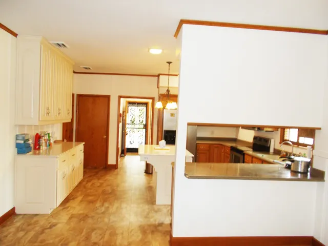 a view of empty room with wooden floor and fireplace