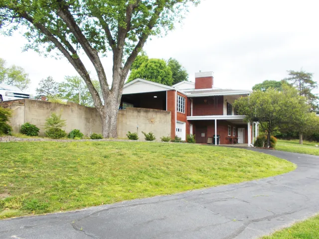 a view of a street with a small yard