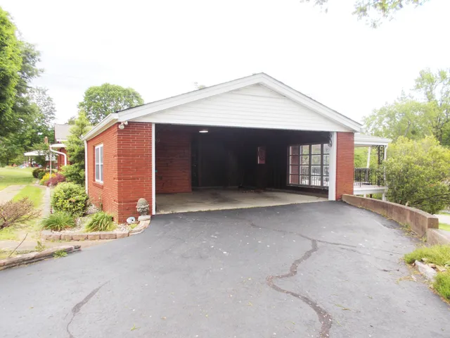 a view of a house with a yard and garage