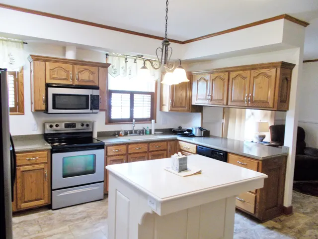 a kitchen with a stove a sink and a refrigerator