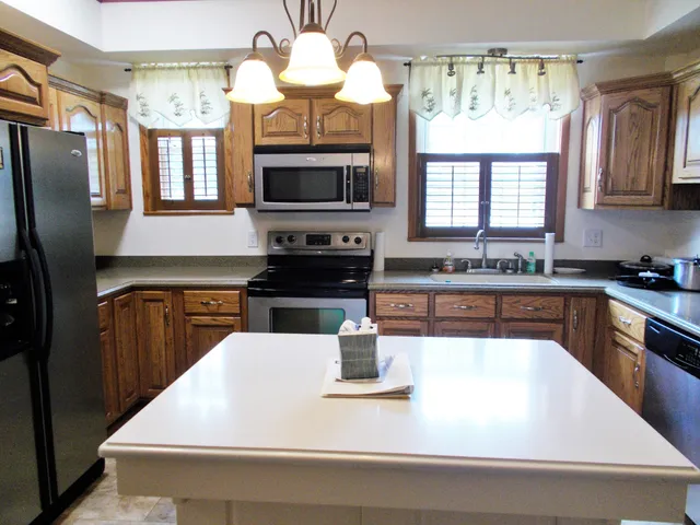 a kitchen with a stove a sink and a refrigerator