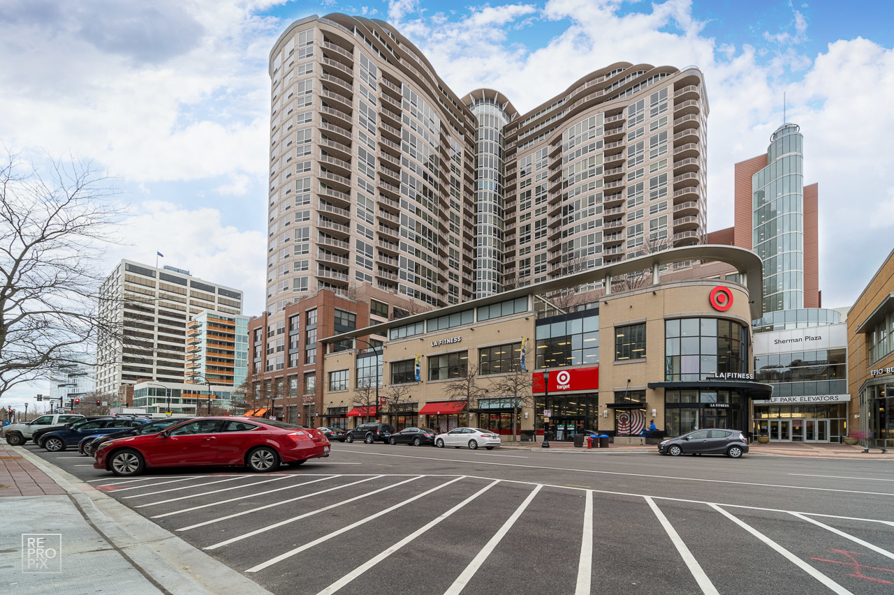 807 Davis Street, Unit 1007 Evanston, IL 60201 - Photo 1 of 14 a front view of a building with lot of cars and trees