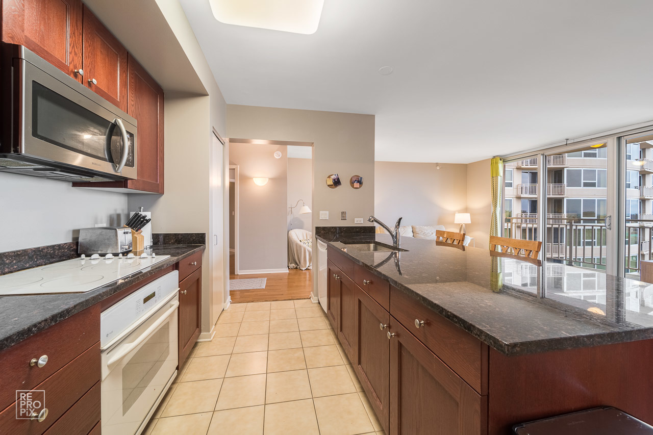 807 Davis Street, Unit 1007 Evanston, IL 60201 - Photo 10 of 14 a kitchen with a sink and a stove top oven