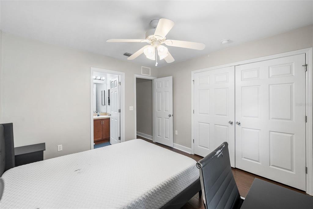 2927 Southwest 35th Place, Unit 113 Gainesville, FL 32608 - Photo 16 of 27 a bedroom with a bed and a chandelier