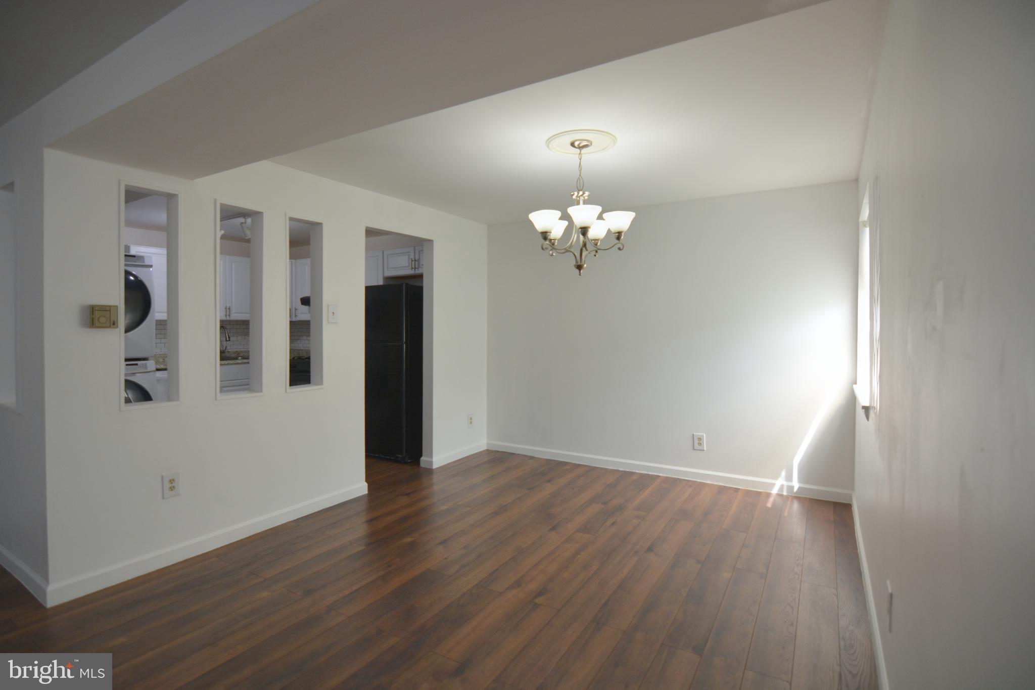 18905 Smoothstone Way, Unit I3 Gaithersburg, MD 20886 - Photo 11 of 32 an empty room with wooden floor
