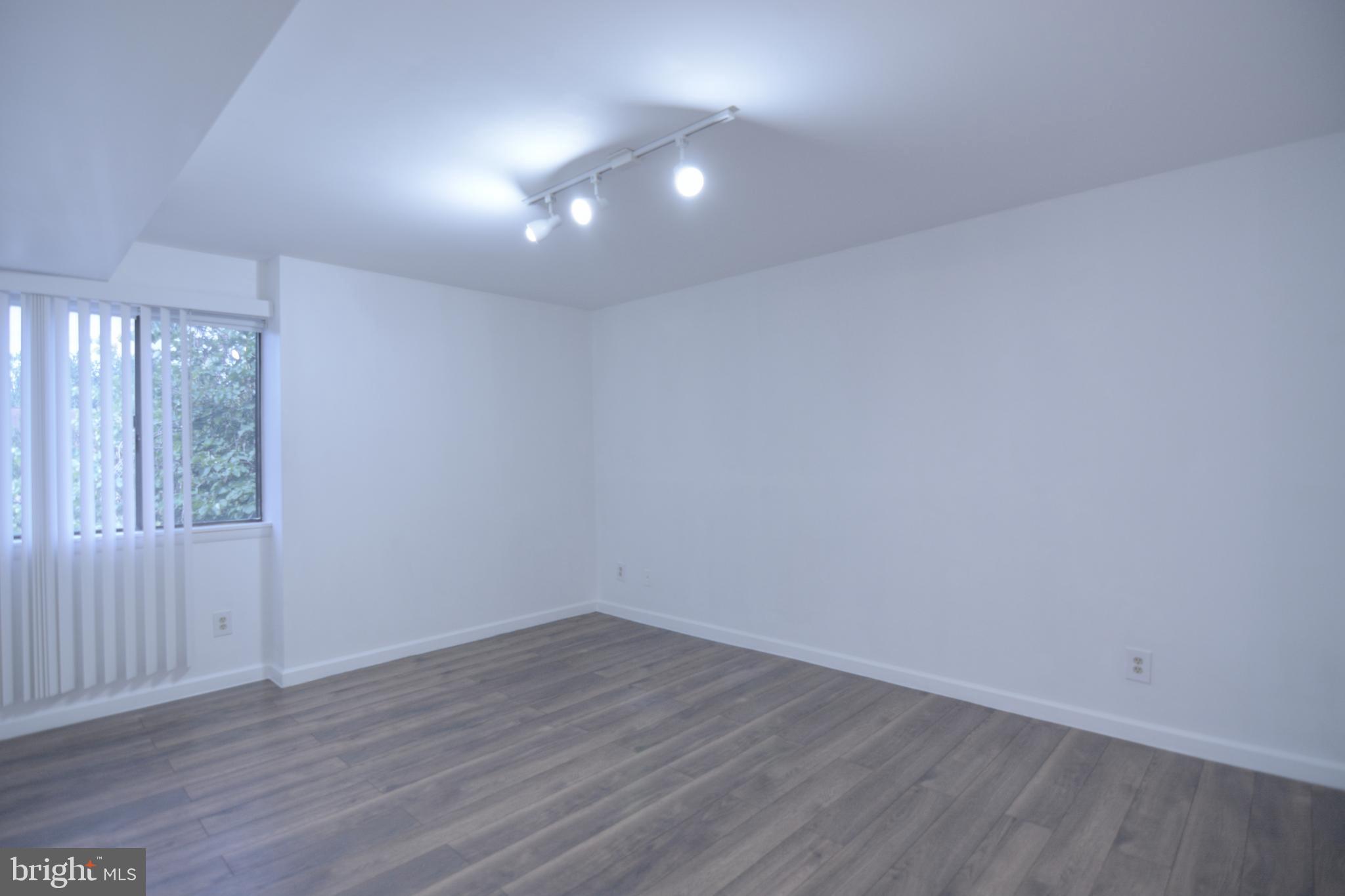 18905 Smoothstone Way, Unit I3 Gaithersburg, MD 20886 - Photo 25 of 32 wooden floor in an empty room with a window