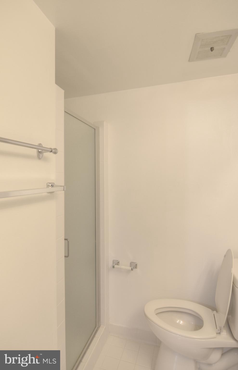 18905 Smoothstone Way, Unit I3 Gaithersburg, MD 20886 - Photo 29 of 32 a bathroom with a toilet and a shower