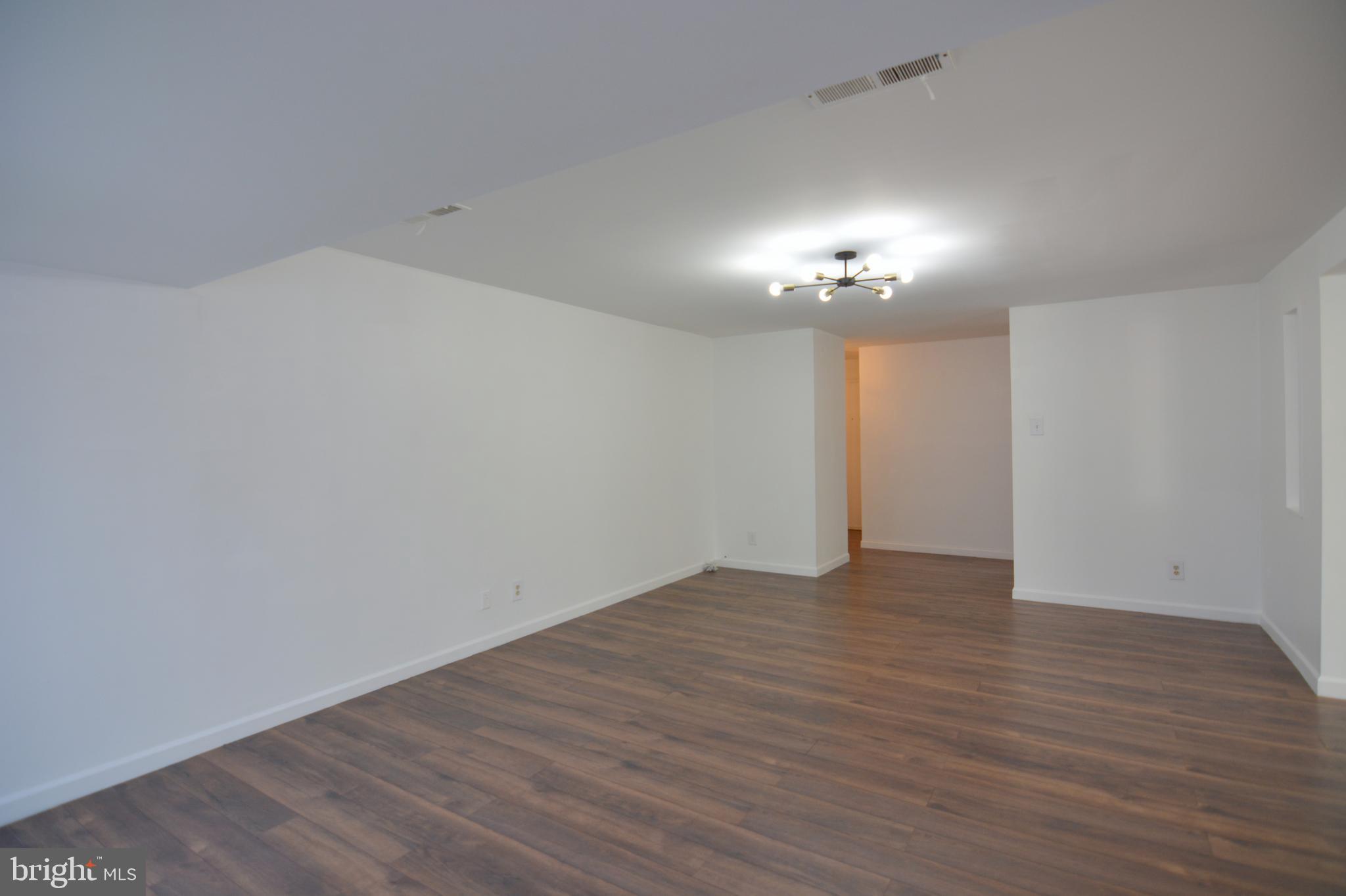 18905 Smoothstone Way, Unit I3 Gaithersburg, MD 20886 - Photo 8 of 32 wooden floor in an empty room