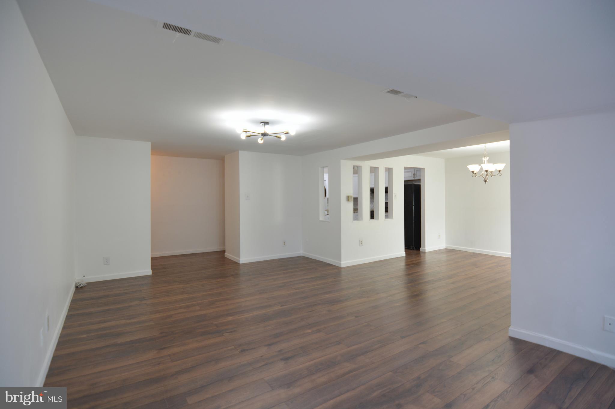 18905 Smoothstone Way, Unit I3 Gaithersburg, MD 20886 - Photo 9 of 32 a view of an empty room with wooden floor