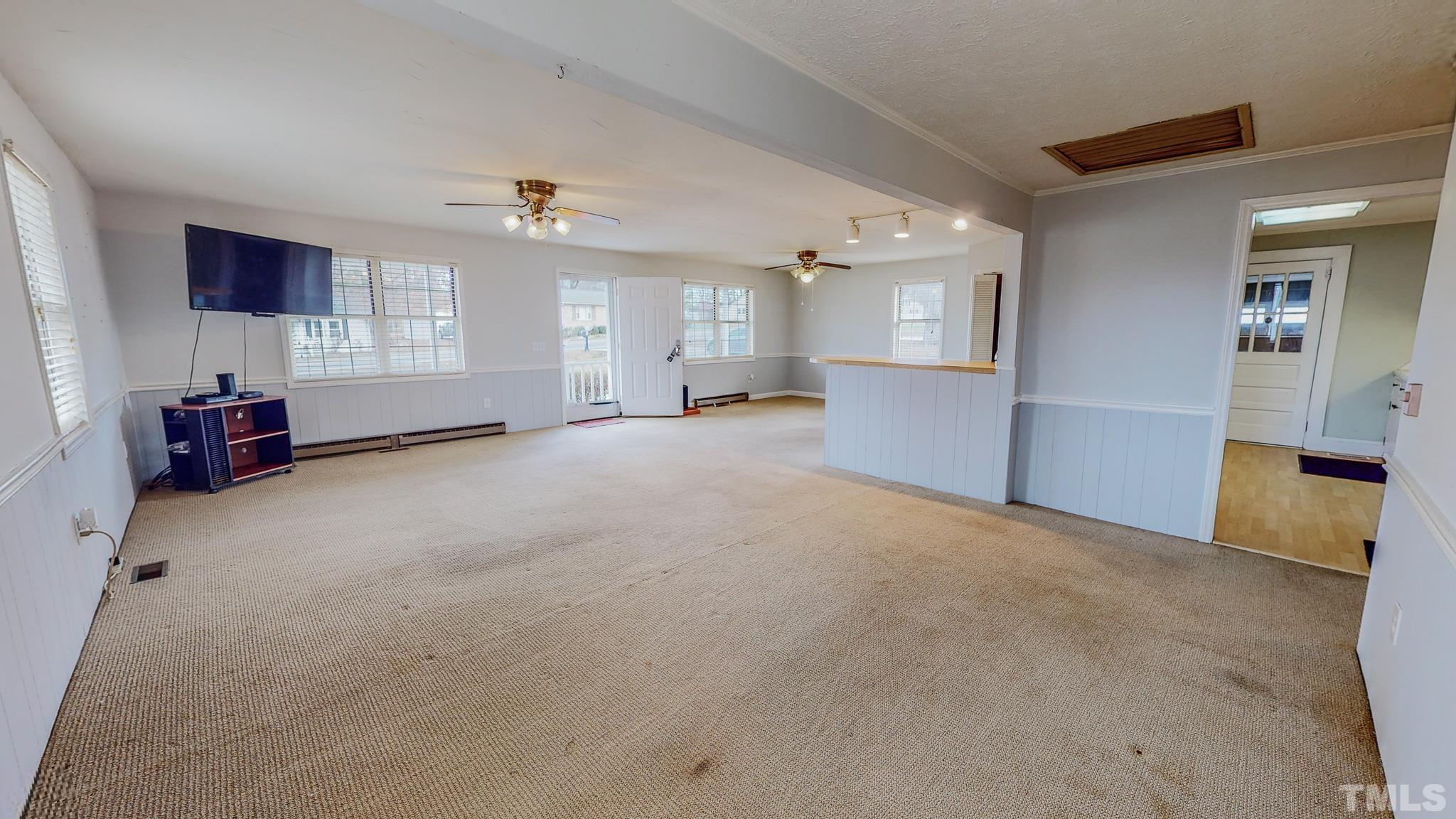 231 Patterson Drive Roxboro, NC 27573 - Photo 18 of 41 an empty room with windows and cabinet