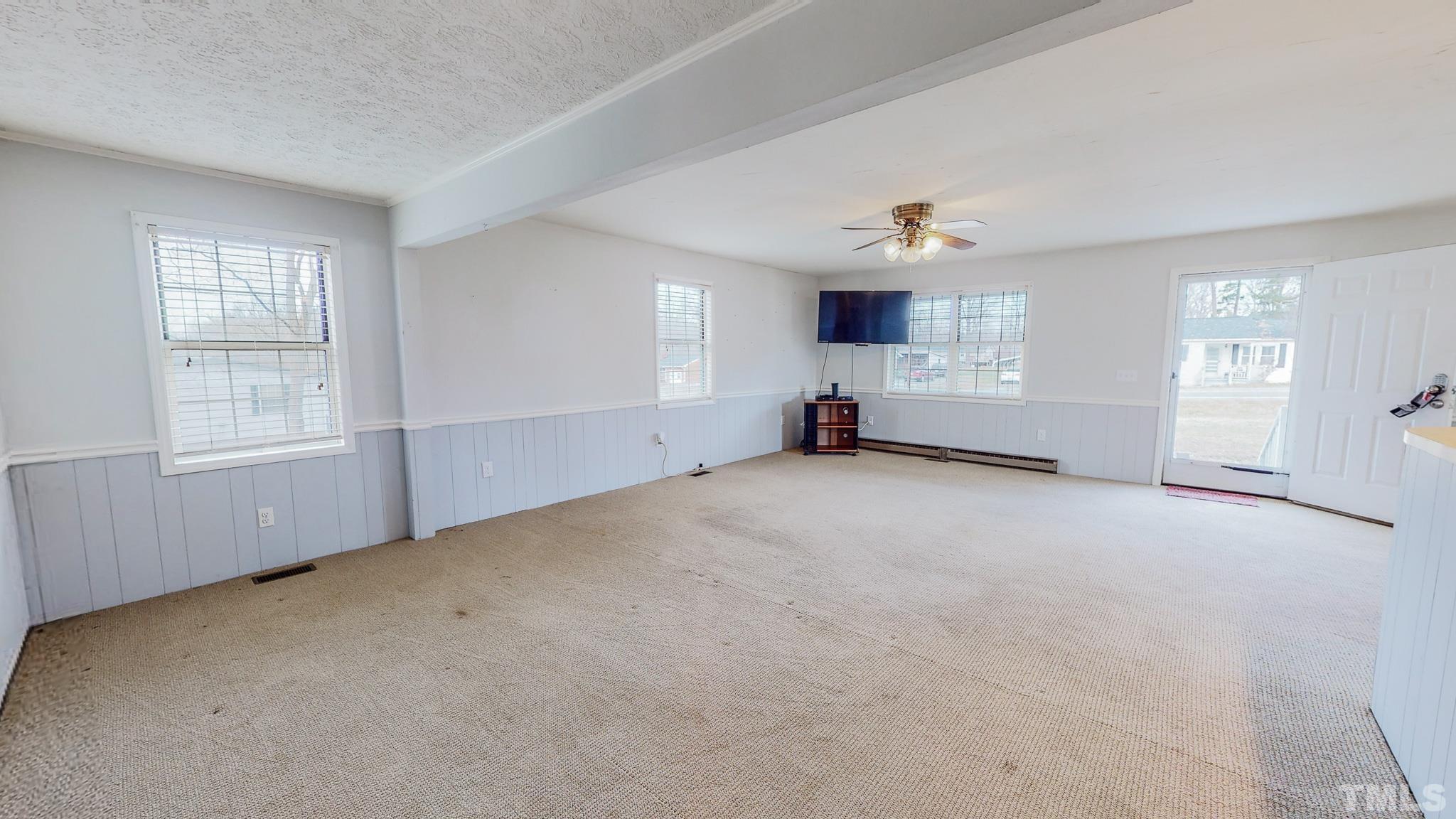 231 Patterson Drive Roxboro, NC 27573 - Photo 19 of 41 an empty room with windows and cabinet