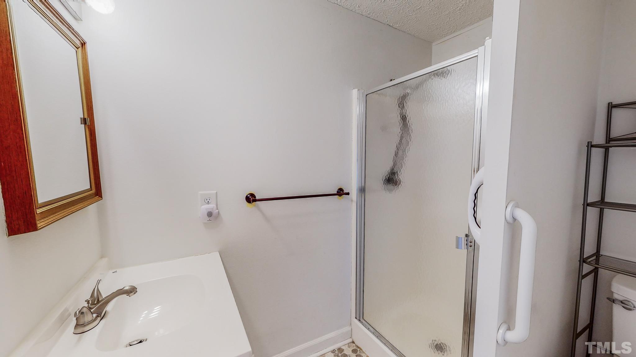 231 Patterson Drive Roxboro, NC 27573 - Photo 26 of 41 a bathroom with a sink and shower