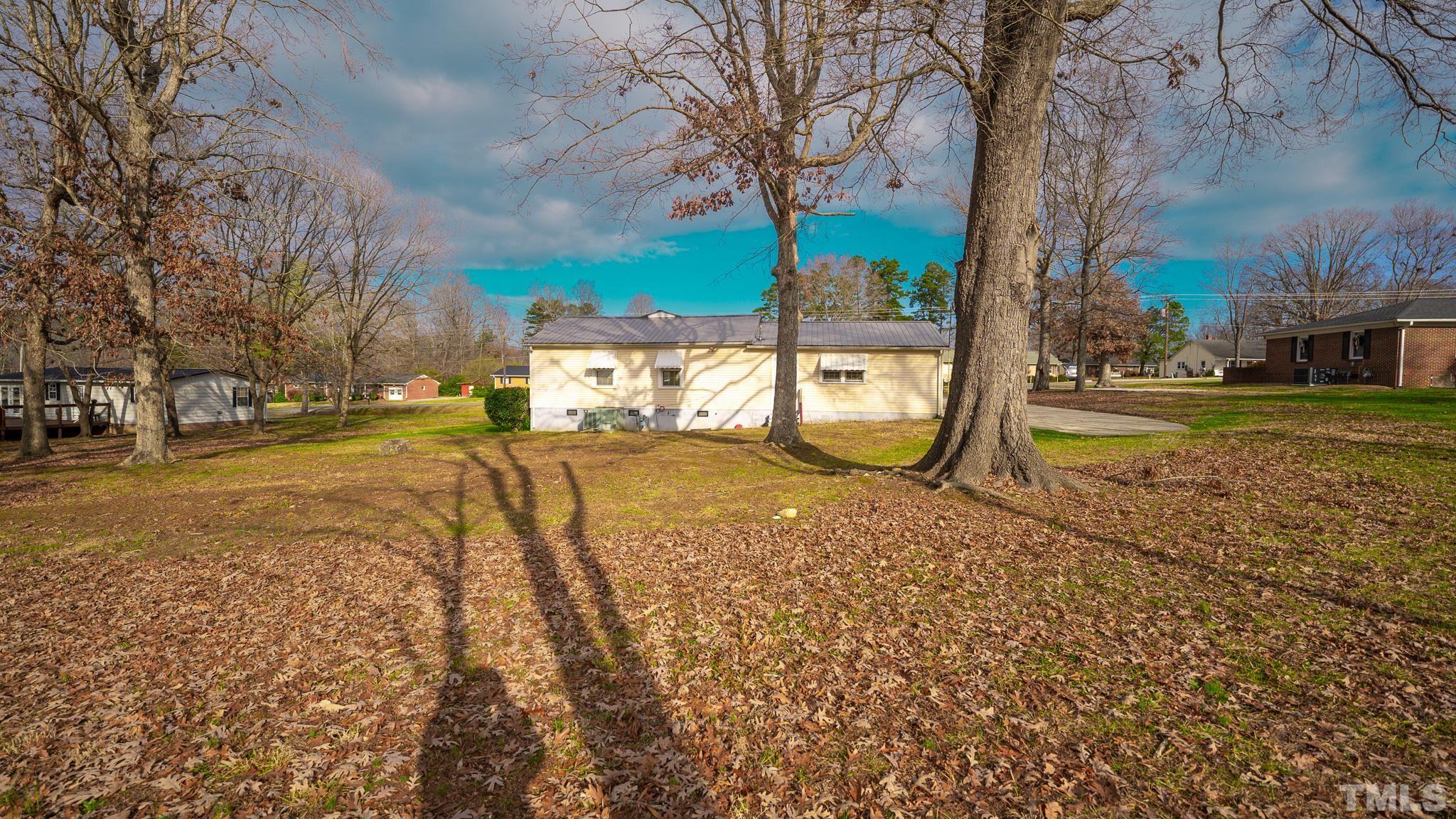 231 Patterson Drive Roxboro, NC 27573 - Photo 33 of 41 a view of a yard with a tree