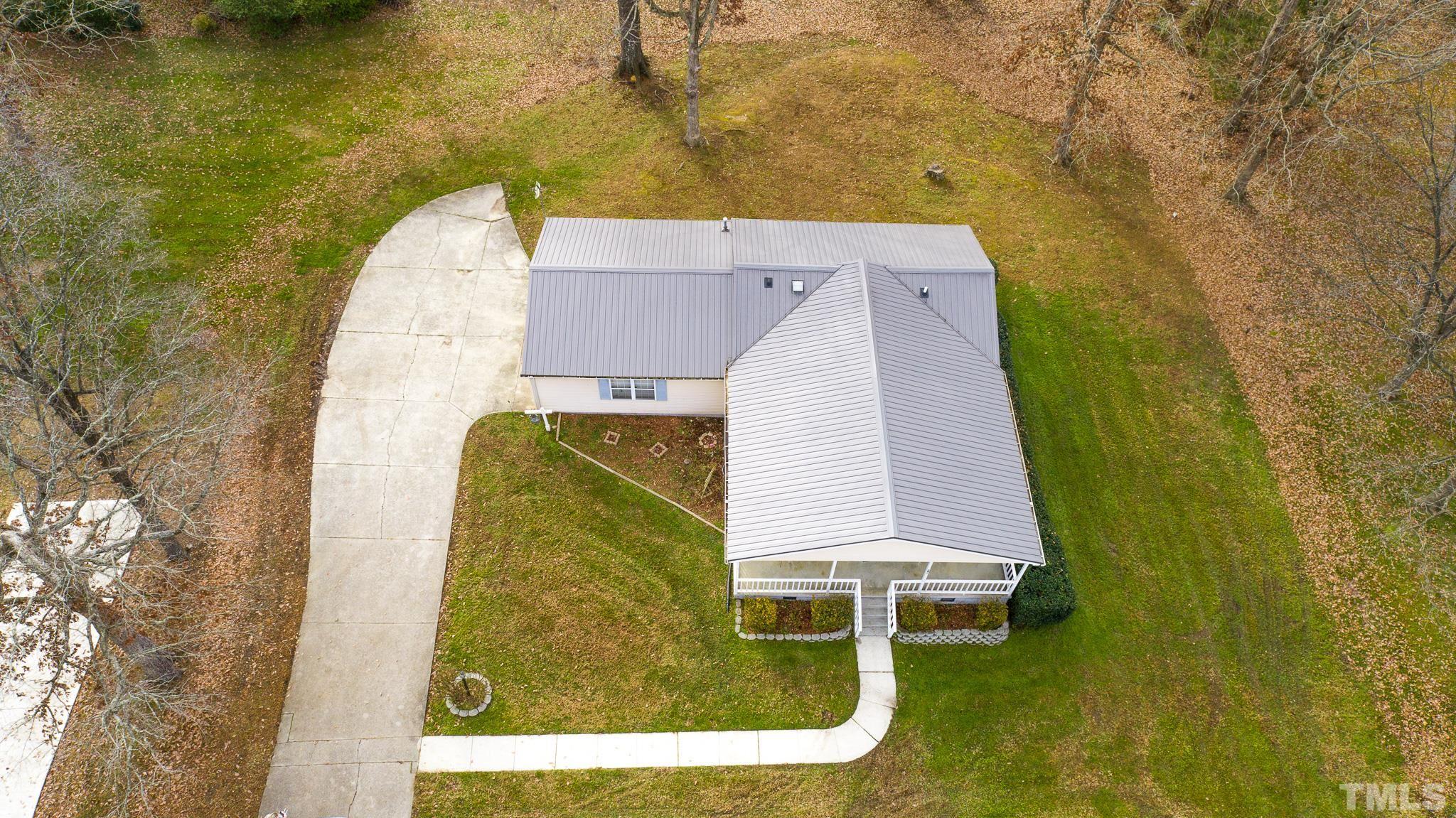 231 Patterson Drive Roxboro, NC 27573 - Photo 40 of 41 an aerial view of a house with a garden and trees