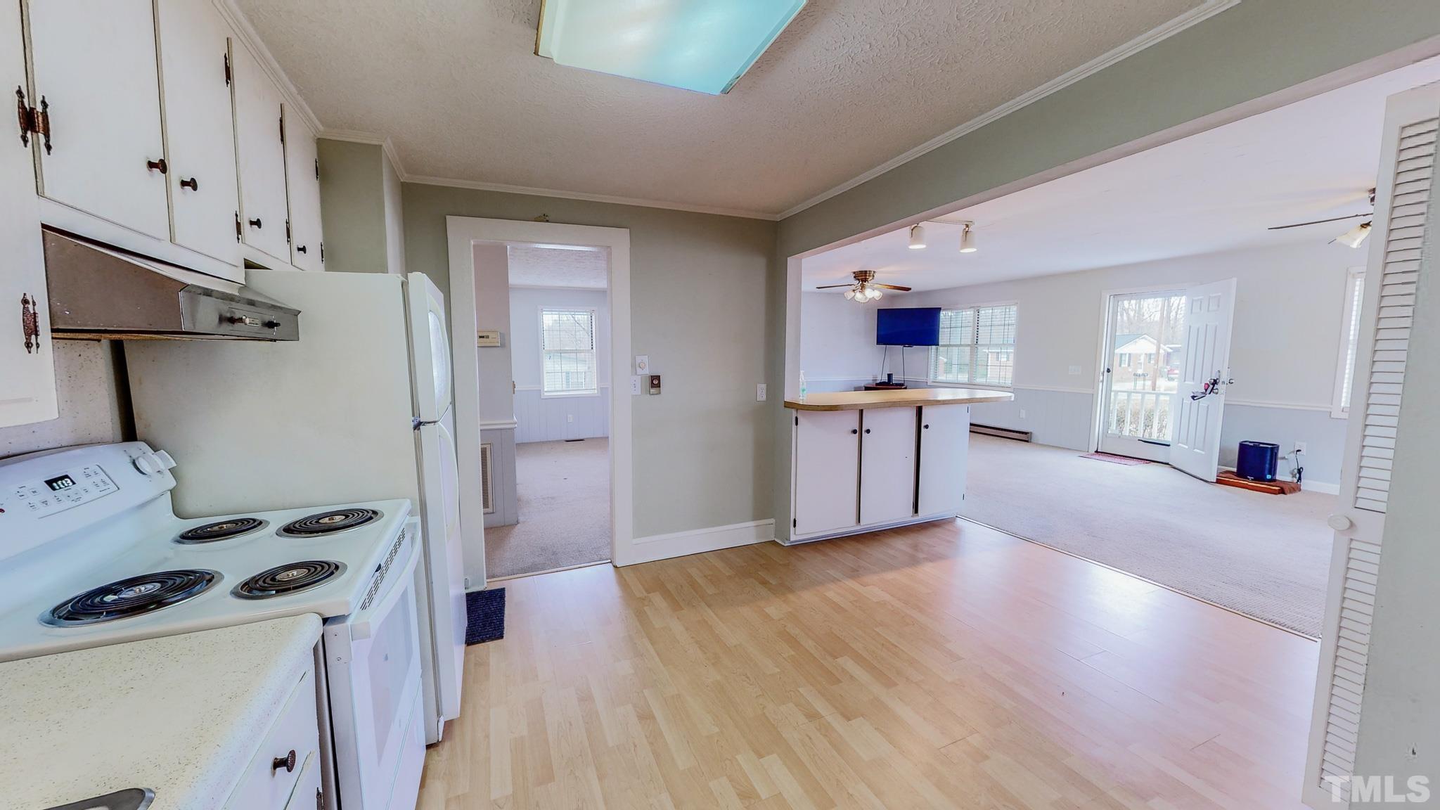 231 Patterson Drive Roxboro, NC 27573 - Photo 5 of 41 a view of a kitchen and a sink a living room