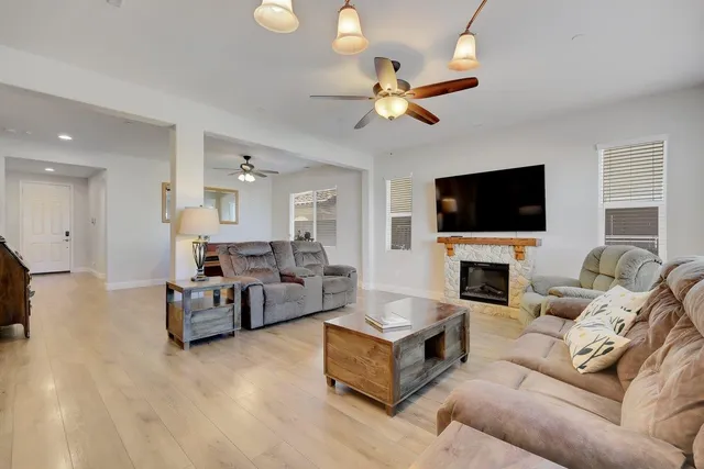 a view of kitchen with granite countertop refrigerator cabinets dining table and chairs