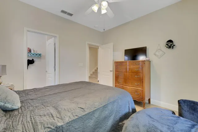 a bed sitting in a bedroom next to a window