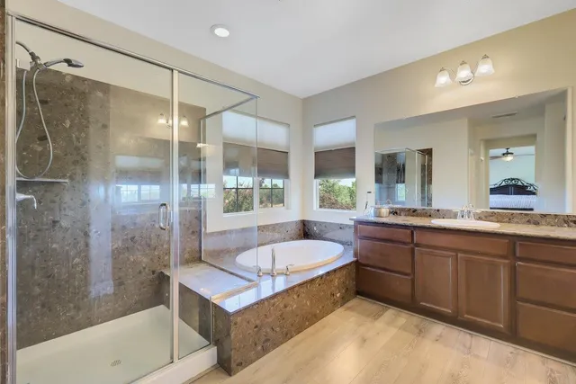 a bedroom with a bed and a flat tv screen on dresser