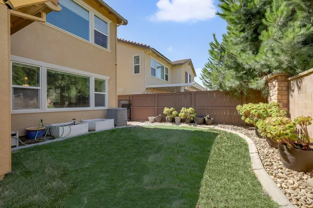 a view of a patio with a dining table and chairs with a patio