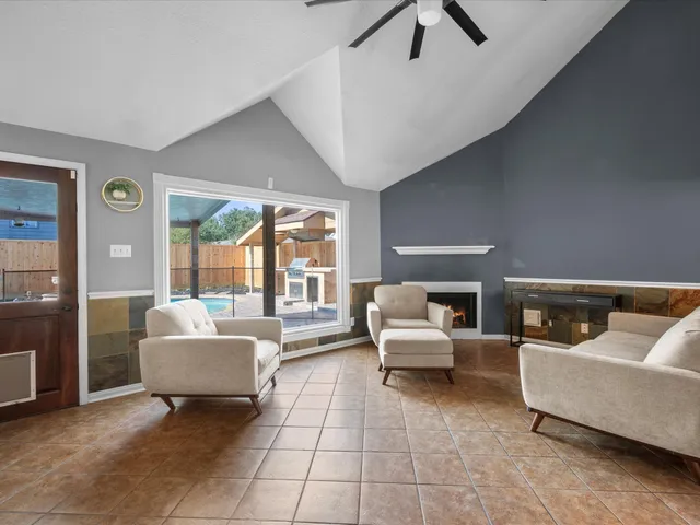 a living room with furniture and a floor to ceiling window