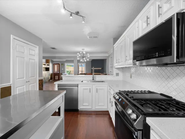 a kitchen with a sink stove and microwave