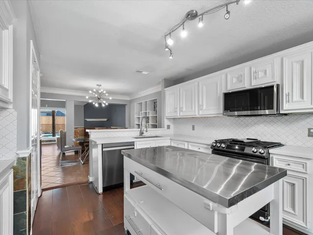 a kitchen with a sink stove and microwave