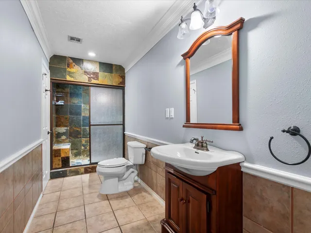 a bathroom with a sink toilet and shower