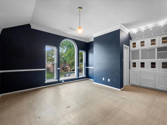 a view of a big room with windows and chandelier