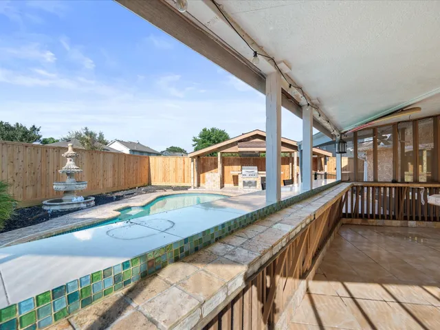 a view of a house with backyard and sitting area