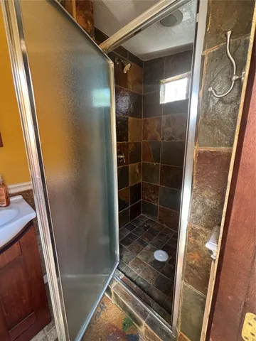 a bathroom with a glass door shower and toilet