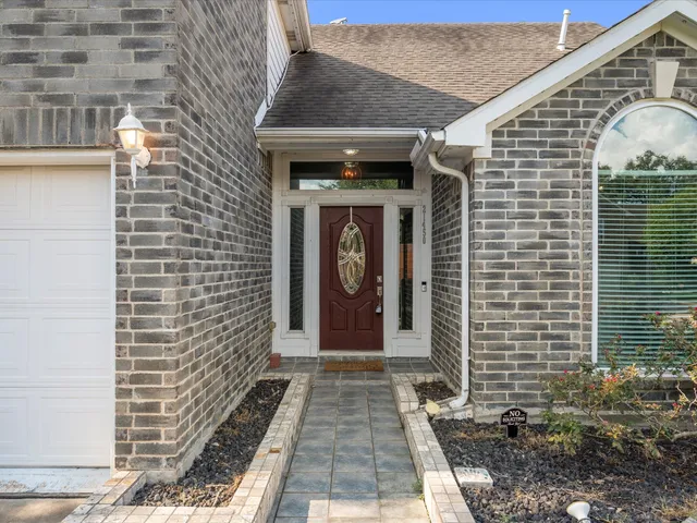 a view of a brick house with large windows