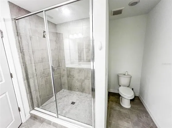 a bathroom with a shower and a toilet