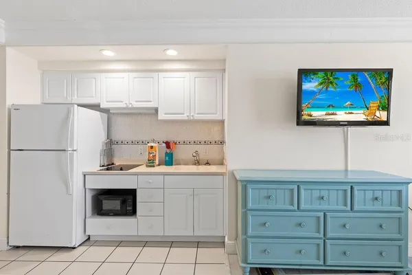 a kitchen with stainless steel appliances granite countertop a sink and a refrigerator