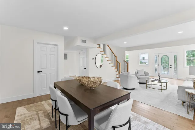 a living room with wooden floor and white walls