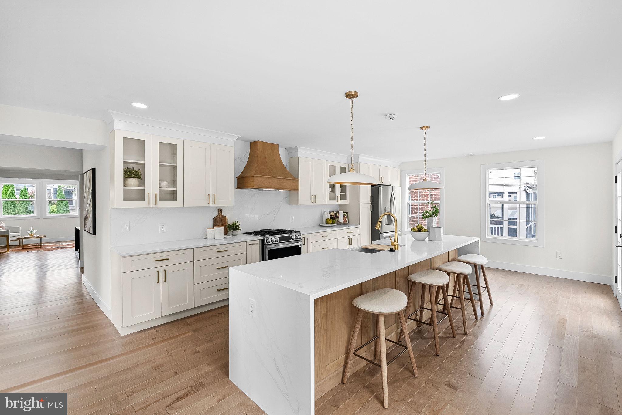 1805 South Pollard Street Arlington, VA 22204 - Photo 20 of 55 a kitchen with stainless steel appliances kitchen island wooden floors and white cabinets