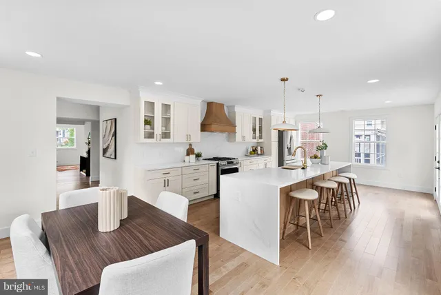a living room with kitchen island furniture and a potted plant