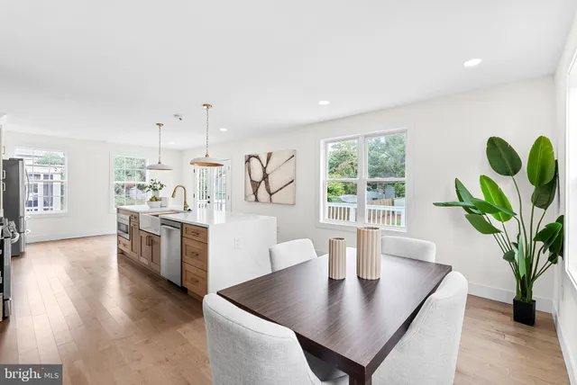 a bedroom with a bed lamp and a large window