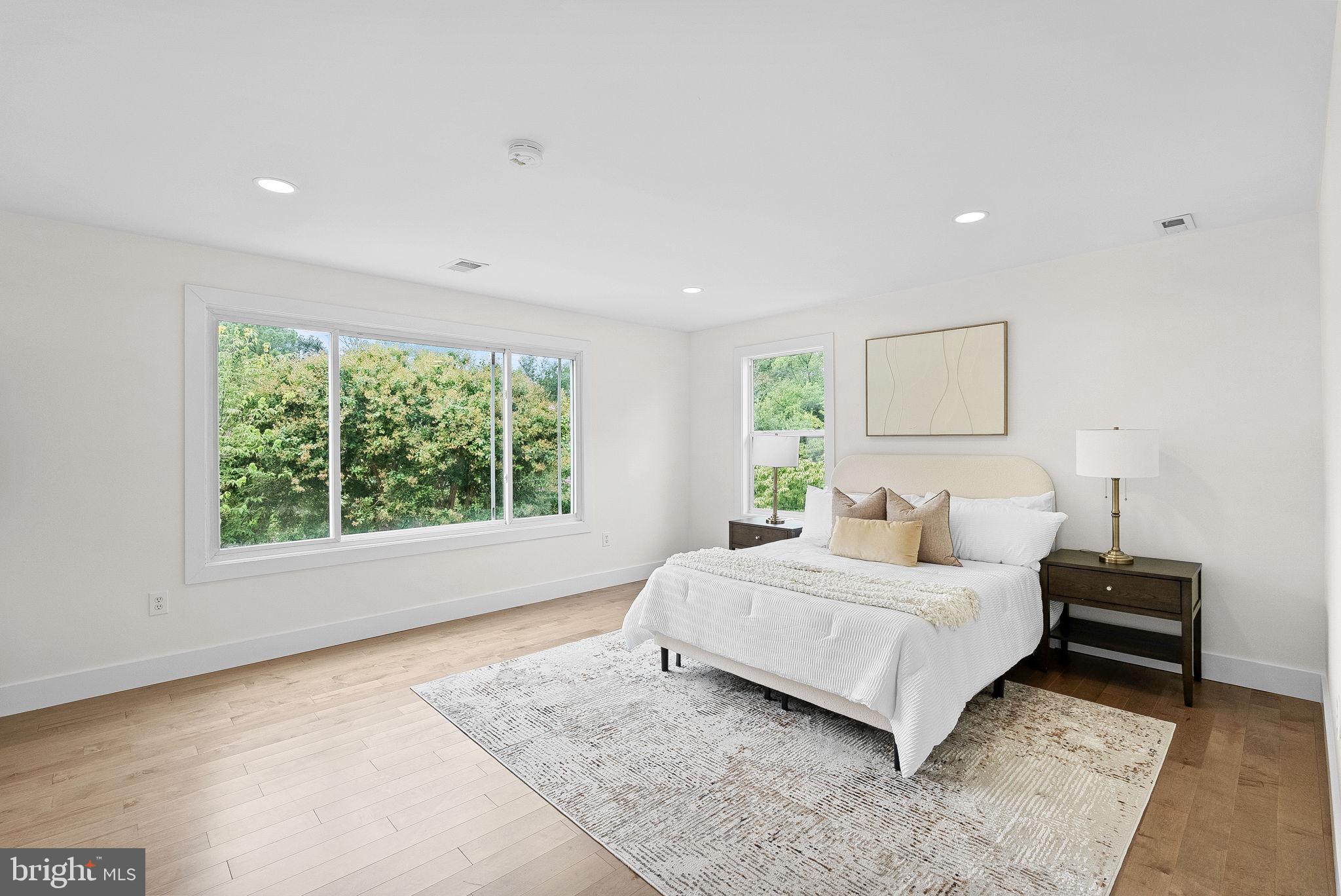 1805 South Pollard Street Arlington, VA 22204 - Photo 28 of 55 a bedroom with a bed lamp and a large window